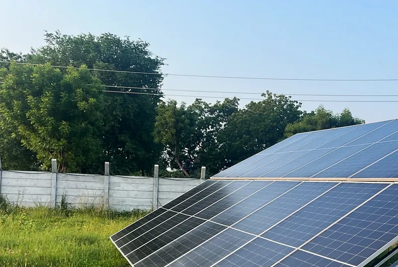 Dreamfusion solar tracker installation, India: tilted solar panels under a clear blue sky